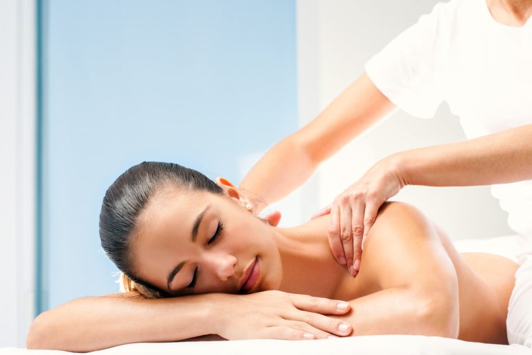 Young woman having spa back massage.